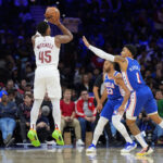 Nov 13, 2024; Philadelphia, Pennsylvania, USA; Cleveland Cavaliers guard Donovan Mitchell (45) shoots the ball against Philadelphia 76ers forward KJ Martin (1) in the second quarter at Wells Fargo Center.