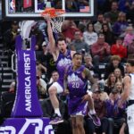 Nov 14, 2024; Salt Lake City, Utah, USA; Utah Jazz forward Drew Eubanks (rear) hangs on the rim after a dunking the ball against the Dallas Mavericks during the third quarter at Delta Center. Mandatory Credit: Rob Gray-Imagn Images