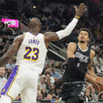 Nov 15, 2024; San Antonio, Texas, USA; San Antonio Spurs center Victor Wembanyama (1) drives to the basket past Los Angeles Lakers forward LeBron James (23) during the first half at Frost Bank Center.