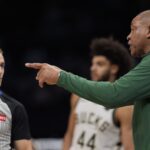 Nov 16, 2024; Charlotte, North Carolina, USA; Milwaukee Bucks head coach Doc Rivers talks with referee Brandon Schwab (86) during the second half against the Charlotte Hornets at Spectrum Center.