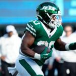 New York Jets running back Breece Hall (20) runs for a first down in the second quarter, Sunday, November 17, 2024, in East Rutherford.