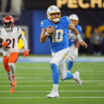 NFL: Cincinnati Bengals at Los Angeles Chargers. Nov 17, 2024; Inglewood, California, USA; Los Angeles Chargers quarterback Justin Herbert (10) carries the ball on a 30-yard run against Cincinnati Bengals cornerback Mike Hilton (21) in the first half at SoFi Stadium. Mandatory Credit: Kirby Lee-Imagn Images