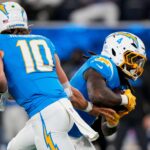 Los Angeles Chargers quarterback Justin Herbert (10) hands off to running back Gus Edwards (4) in the second quarter of the NFL Week 11 game between the Los Angeles Chargers and the Cincinnati Bengals at SoFi Stadium in Inglewood, Calif., on Sunday, Nov. 17, 2024. The Chargers led 24-6 at halftime.