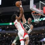 Nov 18, 2024; Milwaukee, Wisconsin, USA; Milwaukee Bucks center Brook Lopez (11) blocks the shot of Houston Rockets guard Amen Thompson (1) during the second quarter at Fiserv Forum. Mandatory Credit: Jeff Hanisch-Imagn Images