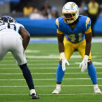 Nov 10, 2024; Inglewood, California, USA; Los Angeles Chargers cornerback Eli Apple (41) and Tennessee Titans cornerback Justin Hardee Sr. (26) during the fourth quarter at SoFi Stadium. Mandatory Credit: Robert Hanashiro-Imagn Images