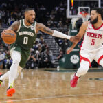 Nov 18, 2024; Milwaukee, Wisconsin, USA; Milwaukee Bucks guard Damian Lillard (0) drives for the basket against Houston Rockets guard Fred VanVleet (5) during the third quarter at Fiserv Forum.