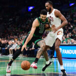 Nov 19, 2024; Boston, Massachusetts, USA; Boston Celtics forward Jayson Tatum (0) drives to the basket while Cleveland Cavaliers forward Evan Mobley (4) defends during the first half at TD Garden