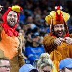 Detroit Lions fans wear turkey outfits during the Thanksgiving Day game against the Green Bay Packers at Ford Field in Detroit on Nov. 23, 2023.