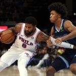 Nov 20, 2024; Memphis, Tennessee, USA; Philadelphia 76ers forward Paul George (8) drives to the basket as Memphis Grizzlies forward Jaylen Wells (0) defends during the first half at FedExForum. Mandatory Credit: Petre Thomas-Imagn Images
