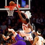 Nov 20, 2024; Phoenix, Arizona, USA; New York Knicks forward OG Anunoby (8) goes for a dunk against Phoenix Suns center Jusuf Nurkic (20) during the second quarter at Footprint Center. Mandatory Credit: Mark J. Rebilas-Imagn Images