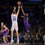 Nov 21, 2024; Los Angeles, California, USA; Orlando Magic forward Franz Wagner (22) hits a 3-point basket over Los Angeles Lakers forward Cam Reddish (5) with 2.5 seconds left in the game at Crypto.com Arena. Mandatory Credit: Jayne Kamin-Oncea-Imagn Images