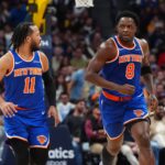 Nov 25, 2024; Denver, Colorado, USA; New York Knicks guard Jalen Brunson (11) reacts towards forward OG Anunoby (8) in the second quarter against the Denver Nuggets at Ball Arena. Mandatory Credit: Ron Chenoy-Imagn Images