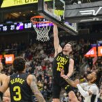 Nov 26, 2024; Salt Lake City, Utah, USA; Utah Jazz forward/center Drew Eubanks (15) dunks over San Antonio Spurs guard Stephon Castle (5) during the first half at the Delta Center. Mandatory Credit: Christopher Creveling-Imagn Images