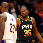 Nov 26, 2024; Phoenix, Arizona, USA; Phoenix Suns forward Kevin Durant (35) talks to Los Angeles Lakers forward LeBron James (23) during the third quarter at Footprint Center. Mandatory Credit: Mark J. Rebilas-Imagn Images