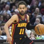 Nov 27, 2024; Cleveland, Ohio, USA; Atlanta Hawks guard Trae Young (11) brings the ball up court in the first quarter against the Cleveland Cavaliers at Rocket Mortgage FieldHouse.