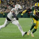 Green Bay Packers wide receiver Jayden Reed (11) outruns Miami Dolphins linebacker Jordyn Brooks (20) to score a touchdown on a reception during the second quarter of their game Thursday, November 28, 2024 at Lambeau Field in Green Bay, Wisconsin.