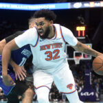 Nov 29, 2024; Charlotte, North Carolina, USA; New York Knicks center Karl-Anthony Towns (32) drives in during the first half against the Charlotte Hornets at the Spectrum Center.