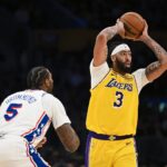 Nov 8, 2024; Los Angeles, California, USA; Los Angeles Lakers forward Anthony Davis (3) looks to pass against Philadelphia 76ers center Andre Drummond (5) during the second half at Crypto.com Arena.