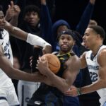 Nov 15, 2024; San Francisco, California, USA; Memphis Grizzlies forward Jaren Jackson Jr. (13) and guard Desmond Bane (22) force a jump ball with Golden State Warriors guard Buddy Hield (7) during the fourth quarter at Chase Center.