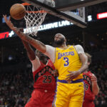 Nov 1, 2024; Toronto, Ontario, CAN; Los Angeles Lakers forward Anthony Davis (3) gets fouled by Toronto Raptors forward Chris Boucher (25) as he goes to make a basket during the first half at Scotiabank Arena. Mandatory Credit: John E. Sokolowski-Imagn Images