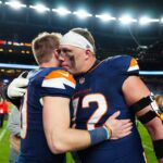 Denver Broncos offensive tackle Garett Bolles (72) hugs quarterback Bo Nix (10) following the win against the Cleveland Browns at Empower Field at Mile High.