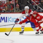 Detroit Red Wings defenseman Albert Johansson (20) fights for control of the puck with Montreal Canadiens left wing Emil Heineman (51) during the third period at Little Caesars Arena.