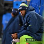Seattle Seahawks quarterback Geno Smith (7) sits on the bench after an injury during the second half against the Green Bay Packers at Lumen Field.