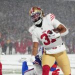 San Francisco 49ers running back Isaac Guerendo (31) runs with the ball for a touchdown against Buffalo Bills safety Damar Hamlin (3) during the second half at Highmark Stadium.