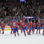 Montreal Canadiens forward Cole Caufield (13) and forward Nick Suzuki (14) celebrate after defeating the Detroit Red Wings at the Bell Centre.