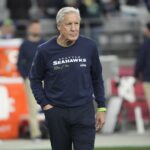 Seattle Seahawks head coach Pete Carroll watches his team warm up before playing against the Arizona Cardinals in Glendale on Jan. 7, 2024.