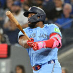 Sep 24, 2024; Toronto, Ontario, CAN; Toronto Blue Jays designated hitter Vladimir Guerrero Jr. (27) hits a two run RBI double against the Boston Red Sox in the third inning at Rogers Centre. Mandatory Credit: Dan Hamilton-Imagn Images