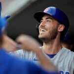 Chicago Cubs center fielder Cody Bellinger celebrates in the dugout after hitting a solo home run during a 2023 game against the Cincinnati Reds at Great American Ball Park.