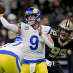 Dec 1, 2024; New Orleans, Louisiana, USA; Los Angeles Rams quarterback Matthew Stafford (9) throws against New Orleans Saints defensive end Chase Young (99) during the first half at Caesars Superdome. Mandatory Credit: Matthew Hinton-Imagn Images