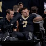 Dec 1, 2024; New Orleans, Louisiana, USA; New Orleans Saints tight end Taysom Hill (7) leaves the field after an injury against the Los Angeles Rams during the second half at Caesars Superdome. Mandatory Credit: Matthew Hinton-Imagn Images