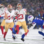 NFL: San Francisco 49ers at Buffalo Bills. Dec 1, 2024; Orchard Park, New York, USA; San Francisco 49ers running back Christian McCaffrey (23) is tackled by Buffalo Bills safety Taylor Rapp (9) and safety Damar Hamlin (3) in the second quarter at Highmark Stadium. Mandatory Credit: Mark Konezny-Imagn Images