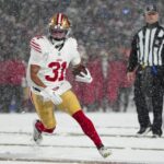Dec 1, 2024; Orchard Park, New York, USA; San Francisco 49ers running back Isaac Guerendo (31) runs with the ball for a touchdown against the Buffalo Bills during the second half at Highmark Stadium. Mandatory Credit: Gregory Fisher-Imagn Images