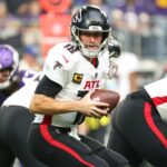 Dec 8, 2024; Minneapolis, Minnesota, USA; Atlanta Falcons quarterback Kirk Cousins (18) takes a snap against the Minnesota Vikings during the first quarter at U.S. Bank Stadium.