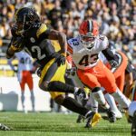 Dec 8, 2024; Pittsburgh, Pennsylvania, USA; Pittsburgh Steelers running back Najee Harris (22) runs past Cleveland Browns linebacker Mohamoud Diabate (43) during the first quarter at Acrisure Stadium. Mandatory Credit: Barry Reeger-Imagn Images