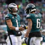 Dec 8, 2024; Philadelphia, Pennsylvania, USA; Philadelphia Eagles wide receiver DeVonta Smith (6) and quarterback Jalen Hurts (1) celebrate their touchdown connection against the Carolina Panthers during the second quarter at Lincoln Financial Field