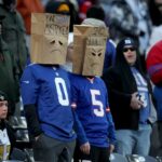 Dec 8, 2024; East Rutherford, New Jersey, USA; New York Giants fans wear paper bags on their heads during the fourth quarter against the New Orleans Saints at MetLife Stadium.