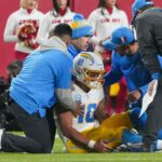 Dec 8, 2024; Kansas City, Missouri, USA; Los Angeles Chargers quarterback Justin Herbert (10) is tended to after an injury against the Kansas City Chiefs during the first half at GEHA Field at Arrowhead Stadium. Mandatory Credit: Denny Medley-Imagn Images