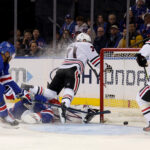 Chicago Blackhawks left wing Taylor Hall (71) scores a goal against New York Rangers goaltender Igor Shesterkin (31) in front of Rangers defenseman K'Andre Miller (79) and Blackhawks center Connor Bedard (98) during the second period at Madison Square Garden.