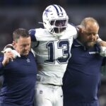 Dec 9, 2024; Arlington, Texas, USA; Dallas Cowboys linebacker DeMarvion Overshown (13) is helped off the field after an injury in the second half against the Cincinnati Bengals at AT&T Stadium.