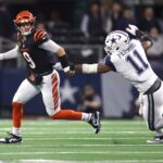 Dec 9, 2024; Arlington, Texas, USA; Cincinnati Bengals quarterback Joe Burrow (9) avoids the tackle of Dallas Cowboys linebacker Micah Parsons (11) in the second half at AT&T Stadium. Mandatory Credit: Tim Heitman-Imagn Images
