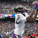 Dec 15, 2024; East Rutherford, New Jersey, USA; Baltimore Ravens wide receiver Rashod Bateman (7) catches a touchdown pass in front of New York Giants safety Dane Belton (24) during the first half at MetLife Stadium. Mandatory Credit: Vincent Carchietta-Imagn Images