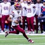 Dec 15, 2024; New Orleans, Louisiana, USA; Washington Commanders quarterback Jayden Daniels (5) scrambles against the New Orleans Saints during the second half at Caesars Superdome. Mandatory Credit: Stephen Lew-Imagn Images