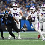 Dec 15, 2024; Detroit, Michigan, USA; Buffalo Bills quarterback Josh Allen (17) scrambles for a first down against the Detroit Lions in the first quarter at Ford Field.