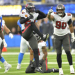Dec 15, 2024; Inglewood, California, USA; Tampa Bay Buccaneers linebacker Chris Braswell (43), linebacker Lavonte David (54) and defensive end Logan Hall (90) celebrate after a sack of Los Angeles Chargers quarterback Justin Herbert (10) in the second half at SoFi Stadium. Mandatory Credit: Jayne Kamin-Oncea-Imagn Images