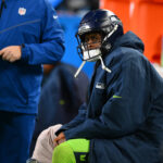 Dec 15, 2024; Seattle, Washington, USA; Seattle Seahawks quarterback Geno Smith (7) sits on the bench after an injury during the second half against the Green Bay Packers at Lumen Field. Mandatory Credit: Steven Bisig-Imagn Images