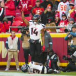 Dec 21, 2024; Kansas City, Missouri, USA; Houston Texans wide receiver Jared Wayne (14) calls for medical staff after an injury to wide receiver Tank Dell (3) during the second half against the Kansas City Chiefs at GEHA Field at Arrowhead Stadium.